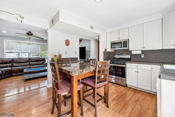 Dining room, Interior, Kitchen, Living room, Recessed Lighting, Stainless Steel Appliances, Wood Texture Flooring