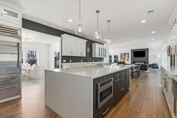 Dining room, Fireplace, Interior, Kitchen, Living room, Pendant Lights, Recessed Lighting, Stainless Steel Appliances, Wood Texture Flooring