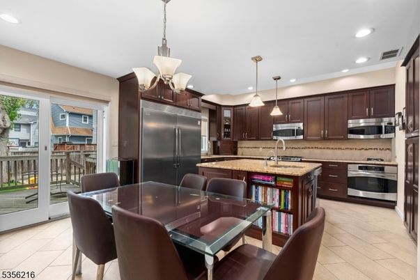 Dining room, Interior, Kitchen, Pendant Lights, Recessed Lighting, Stainless Steel Appliances, Wood Texture Flooring