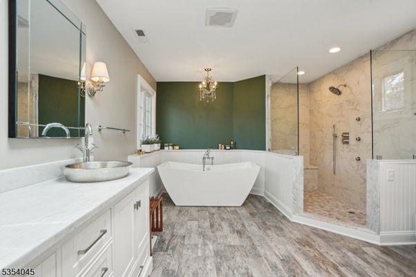 Bathroom, Chandelier, Dual Sink Vanities, Free Standing Baths, Glass Shower, Interior, Marble Walls, Recessed Lighting, Wood Texture Flooring