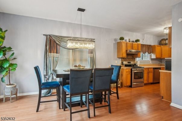 Chandelier, Dining room, Interior, Kitchen, Pendant Lights, Stainless Steel Appliances, Wood Texture Flooring