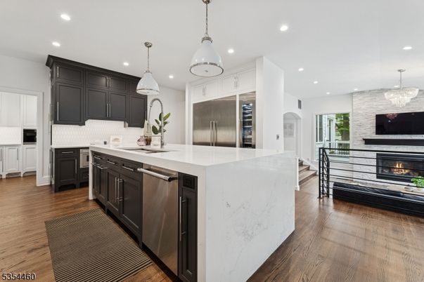 Chandelier, Fireplace, Interior, Kitchen, Pendant Lights, Recessed Lighting, Stainless Steel Appliances, Wood Texture Flooring