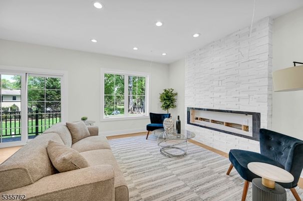 Fireplace, Interior, Living room, Recessed Lighting, Stone Walls, Wood Texture Flooring