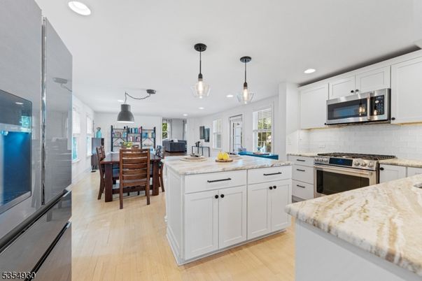 Dining room, Interior, Kitchen, Pendant Lights, Recessed Lighting, Stainless Steel Appliances, Wood Texture Flooring