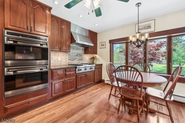 Chandelier, Dining room, Interior, Kitchen, Pendant Lights, Recessed Lighting, Stainless Steel Appliances, Wood Texture Flooring
