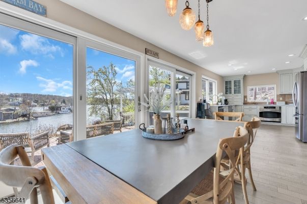 Dining room, Interior, Kitchen, Pendant Lights, Recessed Lighting, Stainless Steel Appliances, Water, Wood Texture Flooring