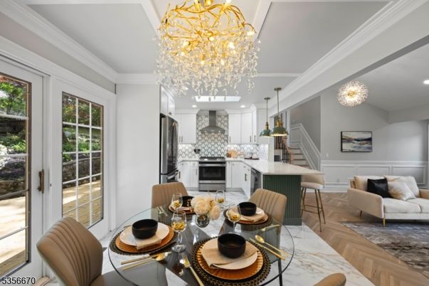 Chandelier, Dining room, Interior, Kitchen, Living room, Pendant Lights, Recessed Lighting, Stainless Steel Appliances, Wood Texture Flooring