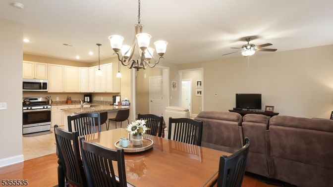 Chandelier, Dining room, Interior, Kitchen, Living room, Pendant Lights, Recessed Lighting, Stainless Steel Appliances, Wood Texture Flooring