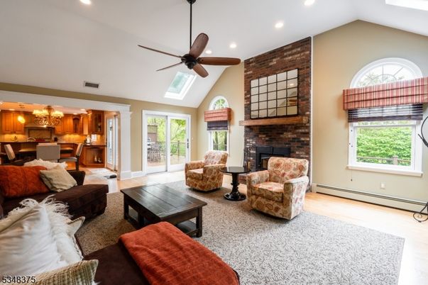 Dining room, Fireplace, Interior, Kitchen, Living room, Recessed Lighting, Stone Walls, Wood Texture Flooring