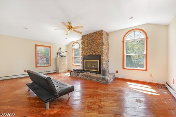 Empty room, Fireplace, Interior, Recessed Lighting, Stone Walls, Wood Texture Flooring