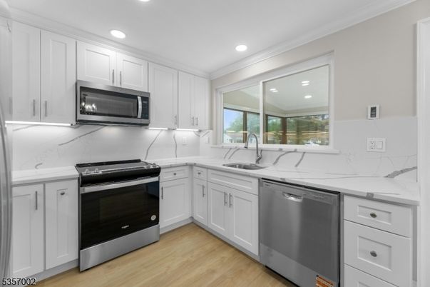 Interior, Kitchen, Marble Walls, Recessed Lighting, Stainless Steel Appliances, Wood Texture Flooring