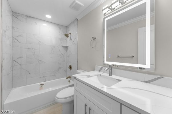 Bathroom, Dual Sink Vanities, Interior, Marble Walls, Recessed Lighting, Wood Texture Flooring