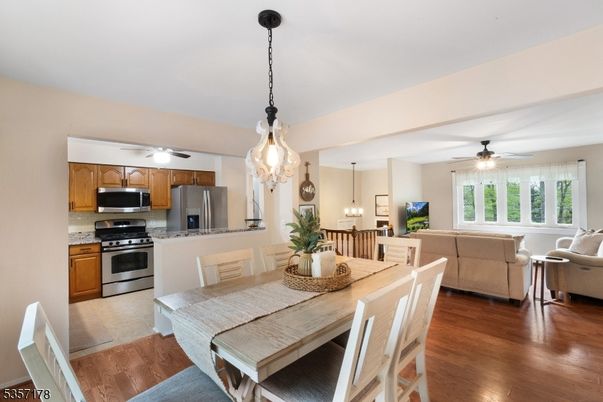 Chandelier, Dining room, Interior, Kitchen, Living room, Pendant Lights, Stainless Steel Appliances, Wood Texture Flooring