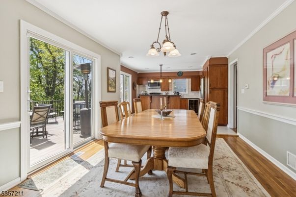 Chandelier, Dining room, Interior, Kitchen, Pendant Lights, Stainless Steel Appliances, Wood Texture Flooring