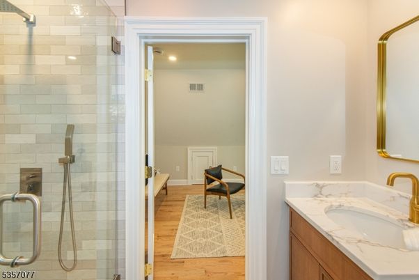 Bathroom, Dual Sink Vanities, Glass Shower, Interior, Recessed Lighting, Wood Texture Flooring