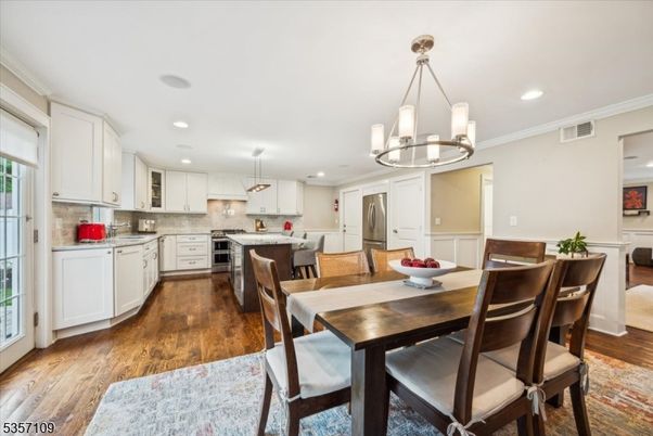 Chandelier, Dining room, Interior, Kitchen, Pendant Lights, Recessed Lighting, Stainless Steel Appliances, Wood Texture Flooring