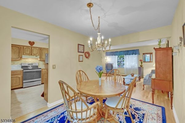 Chandelier, Dining room, Interior, Kitchen, Stainless Steel Appliances, Wood Texture Flooring