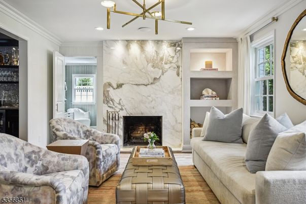 Fireplace, Interior, Living room, Marble Walls, Pendant Lights, Recessed Lighting, Wood Texture Flooring