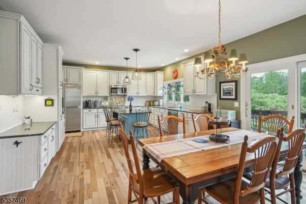 Chandelier, Dining room, Interior, Kitchen, Pendant Lights, Recessed Lighting, Stainless Steel Appliances, Wood Texture Flooring