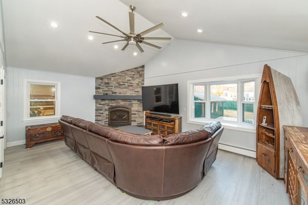 Fireplace, Interior, Living room, Recessed Lighting, Stone Walls, Wood Texture Flooring
