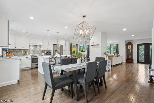 Chandelier, Dining room, Interior, Kitchen, Living room, Pendant Lights, Recessed Lighting, Stainless Steel Appliances, Wood Texture Flooring
