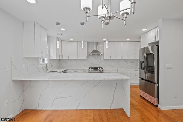 Interior, Kitchen, Marble Walls, Pendant Lights, Recessed Lighting, Stainless Steel Appliances, Wood Texture Flooring
