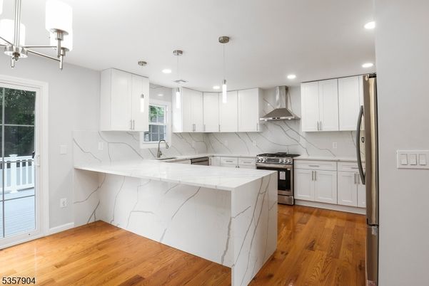 Interior, Kitchen, Marble Walls, Pendant Lights, Recessed Lighting, Stainless Steel Appliances, Wood Texture Flooring