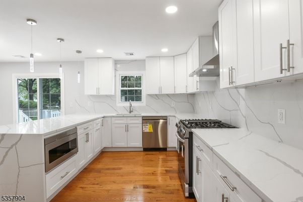 Interior, Kitchen, Marble Walls, Pendant Lights, Recessed Lighting, Stainless Steel Appliances, Wood Texture Flooring