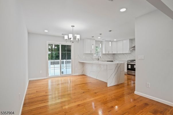 Interior, Kitchen, Marble Walls, Pendant Lights, Recessed Lighting, Stainless Steel Appliances, Wood Texture Flooring