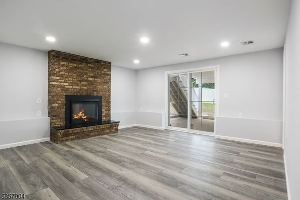 Empty room, Fireplace, Interior, Recessed Lighting, Stone Walls, Wood Texture Flooring