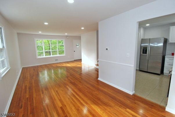 Empty room, Interior, Kitchen, Recessed Lighting, Stainless Steel Appliances, Wood Texture Flooring