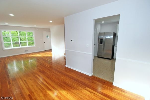 Empty room, Interior, Kitchen, Recessed Lighting, Stainless Steel Appliances, Wood Texture Flooring
