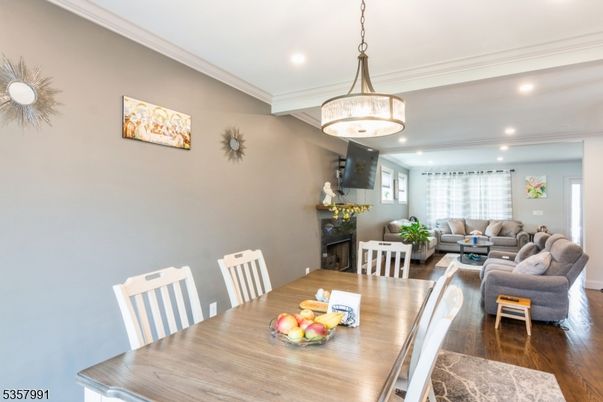 Dining room, Fireplace, Interior, Living room, Pendant Lights, Recessed Lighting, Wood Texture Flooring