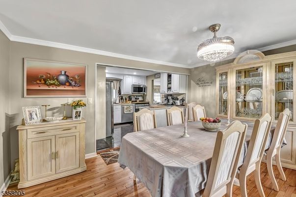 Chandelier, Dining room, Interior, Kitchen, Stainless Steel Appliances, Wood Texture Flooring