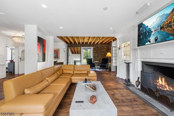 Chandelier, Fireplace, Interior, Living room, Recessed Lighting, Stone Walls, Wooden Beams, Wood Texture Flooring