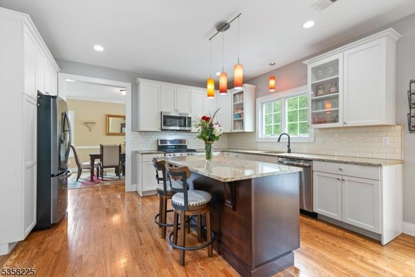 Dining room, Interior, Kitchen, Pendant Lights, Recessed Lighting, Stainless Steel Appliances, Wood Texture Flooring