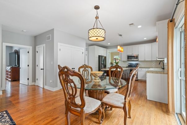 Dining room, Interior, Kitchen, Pendant Lights, Recessed Lighting, Stainless Steel Appliances, Wood Texture Flooring