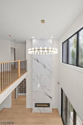Fireplace, Interior, Marble Walls, Pendant Lights, Recessed Lighting, Wood Texture Flooring