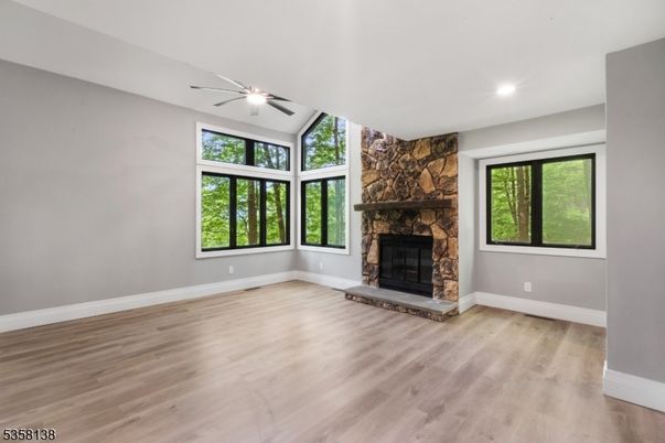 Empty room, Fireplace, Interior, Recessed Lighting, Stone Walls, Wood Texture Flooring