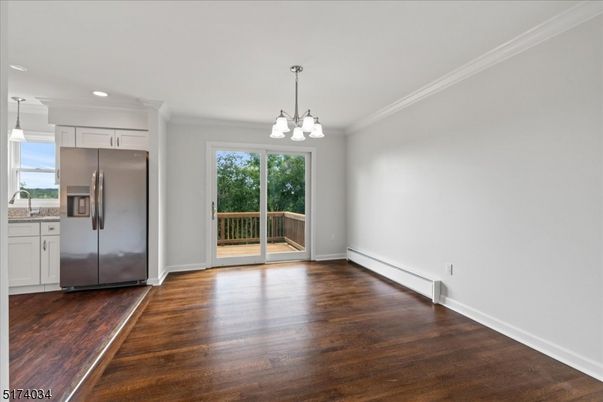 Empty room, Interior, Kitchen, Pendant Lights, Recessed Lighting, Stainless Steel Appliances, Wood Texture Flooring