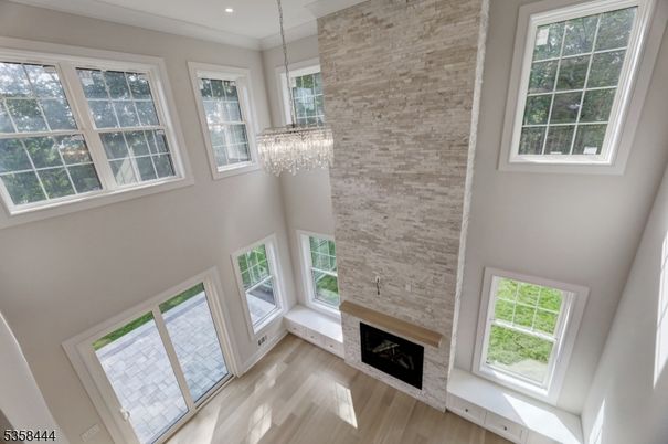 Chandelier, Fireplace, Interior, Recessed Lighting, Stone Walls, Wood Texture Flooring