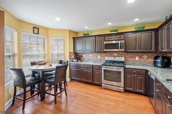 Dining room, Interior, Kitchen, Recessed Lighting, Stainless Steel Appliances, Wood Texture Flooring
