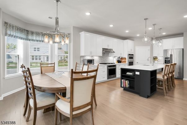 Dining room, Interior, Kitchen, Pendant Lights, Recessed Lighting, Stainless Steel Appliances, Wood Texture Flooring