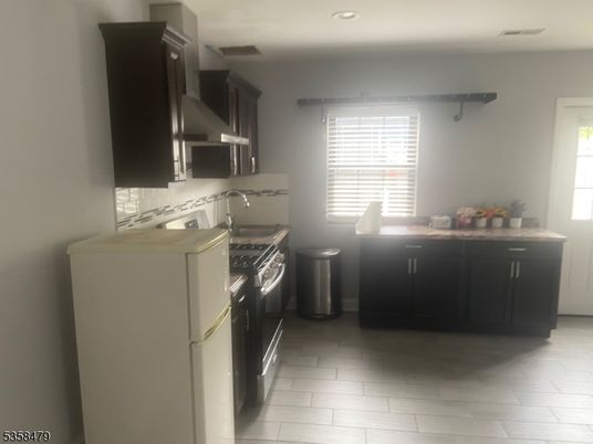 Interior, Kitchen, Recessed Lighting, Washer, Wood Texture Flooring