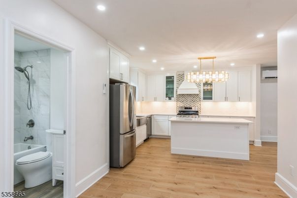 Interior, Kitchen, Marble Walls, Pendant Lights, Recessed Lighting, Stainless Steel Appliances, Wood Texture Flooring