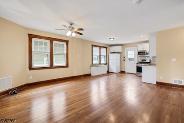 Empty room, Interior, Kitchen, Recessed Lighting, Stainless Steel Appliances, Wood Texture Flooring