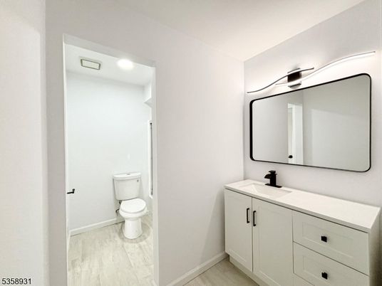Bathroom, Dual Sink Vanities, Interior, Marble, Recessed Lighting, Wood Texture Flooring
