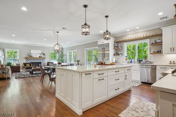 Dining room, Fireplace, Interior, Kitchen, Living room, Pendant Lights, Recessed Lighting, Stainless Steel Appliances, Wood Texture Flooring