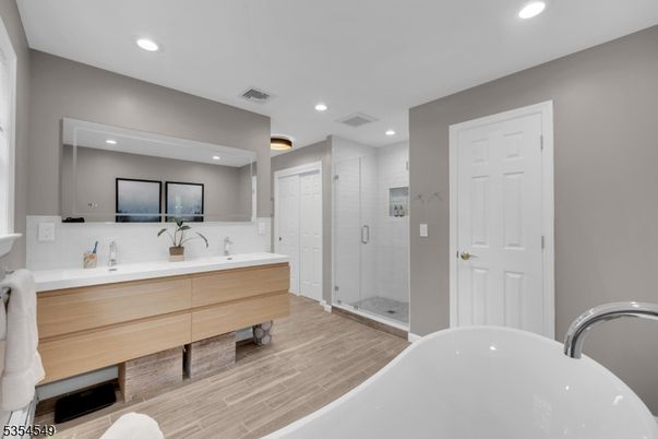 Bathroom, Dual Sink Vanities, Free Standing Baths, Glass Shower, Interior, Recessed Lighting, Wood Texture Flooring