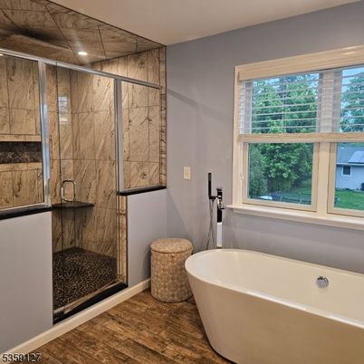 Bathroom, Free Standing Baths, Glass Shower, Interior, Marble Walls, Recessed Lighting, Wood Texture Flooring
